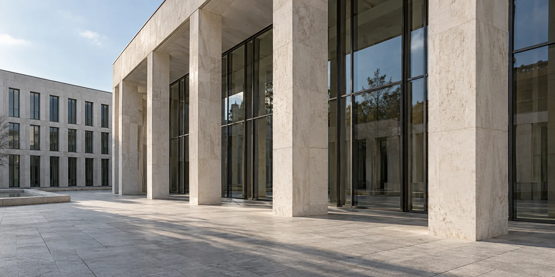 Pale stone colonnade overlooking a quiet courtyard